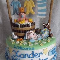 Xander's Baby Shower Cake Cake is covered in mmf with decorations made from chocolate and gumpaste. Everything is edible except the clothes line. Everyone loved it...