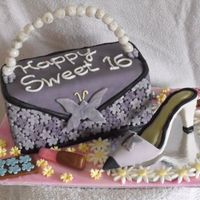 Sweet 16 Cake is covered in mmf with gumpaste and chocolate accessories. This is my first purse cake and shoe so I am very happy with the results.