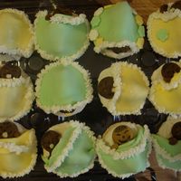 Baby Cupcakes made for my cousin's baby shower babies and blankets made out of fondant on yellow cupcakes