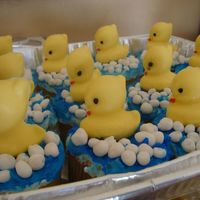 Dsc02828.jpg made for my cousin's baby shower yellow chocolate rubber duckies on blue airbrused vanilla frostin yellow cupcake with fondant bubbles...