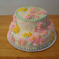 First Cake Words can not express how I feel about this cake... my first one. Top tier isn't centered. Lumpy buttercream. Wretched drop flowers in...