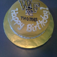 Wake Forest Birthday Buttercream cake airbrushed gold with color flow decal and buttercream details.