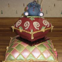 Nights In India Two stacked pillow cakes adorned with a fondant elephant on the top. Cakes are decorated with individually applied and painted sequins,...