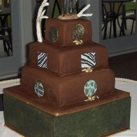 Hunters Groom Cake Three tiered covered in chocolate fondant with chocolate rope trim. Rope knot's painted in gold luster dust and sugar sheet cut out&#...