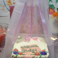 Baby Bassinet Buttercream w/a fondant blanket, and royal icing roses.