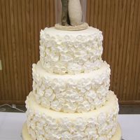 Jessica And Sean White cake with raspberry buttercream filling. Iced in buttercream, covered in ivory fondant and decorated with royal icing flowers. Based...