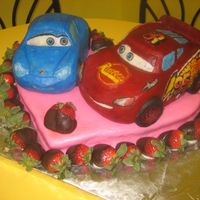 Sally & Mcqueen This cake is for my daughters 3rd birthday. She wanted McQueen & Sally to be "holding tires" (they are actually touching...