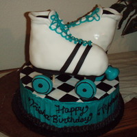 Break Skate Round cake with RCT skates. Fondant accent on Skates and Buttercream on cake sides with fondant top.
