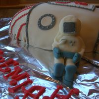 Space Rocket Ship Cake With Astronaut Made in a football pan, covered in fondant. I wished I had covered my board in something else. The foil really took away from the cake I...