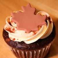 Chocolate Stout Cupcake chocolate stout cupcake, buttercream frosting, fondant cutouts on top, dusted with cocoa