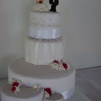 My First Wedding Cake Choc mud, caramel mud and white mud all covered in ganache and fondant. Bride and groom figurines are gumpaste. It didn't turn out as...