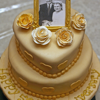 50Th Anniversary Cake This was a bottom round 10" with an 8" heart on top. It was covered with Rhonda's MMF. These were my first ever sugar roses...