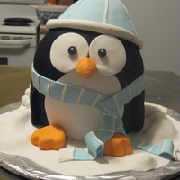 Christmas Penguin Four layers of white and chocolate cake; gumpaste beanie, scarf, snowdrifts and snowballs.