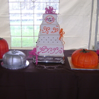 Fall Wedding four tiered brides cake, white and chocolate tiers. Pink & orange scrolls and chocolate dots. Three pumpkin grooms cakes; lemon,...