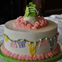 Baby Clothes Gumpaste clothes cut with cricut on buttercream, gumpaste shoe on top