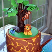Jungle Cake buttercream, fondant accents on cake, gumpaste animals, and rkt tree painted with chocolate