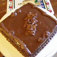 Poured Chocolate Cake This is a simple yellow cake with a milk chocolate frosting. I heated it up and poured it on the cake. Roses and borders also made from...
