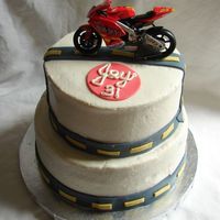 Motorcycle Birthday Cake Happy Birthday, Jay! 2 tier, chocolate fudge cake, iced in butter cream with fondant accents. Motorcycle is a toy.
