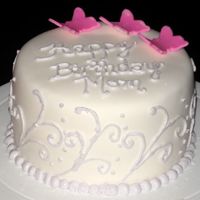 First Fondant Cake This was my first attempt at covering a cake in fondant. It didn't turn out too bad...my piping needs some help though!