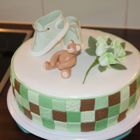 Christening Cake With Shoes, Roses And A Teddybear Christening cake for a little boy. The mom wanted green roses, green shoes and green quilting. Cake and decorations are all made of fondant...