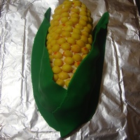 Corn Cob Cake Pound cake cut to shape, thin layer of icing, candy corn as kernels, fondant husks