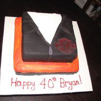 Harley Jacket Birthday Cake This is my first fondant covered cake. Chocolate WASC with chocolate IMBC covered in MMF & Satin Ice.