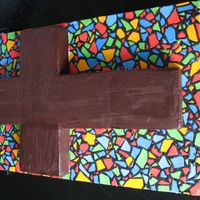 Fr Anthony Going Away Cake Chocolate cake covered in chocolate ganache. Cake board made to look like stained glass window - fondant pieces with RI in between.