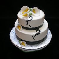 001_-_Copy.jpg Practice cake I made at cake class. Calla lillies made from gumpaste and cake is covered in fondant as well as the ribbon