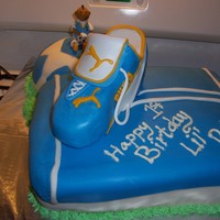 Soccer Themed 1St Bday Puma Shoe is RCT covered in gumpaste....Cake is Strawberry Cream cheese filling covered with MMF. Soccer Ball is Cream Cheese filling...