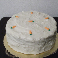 Carrot Cake 2 layer carrot cake filled and topped with cream cheese buttercream, the carrots are pre-made sugart art purchased from a candy supply...