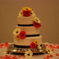 Wedding 12-10-8 buttercream with brown ribbon and fresh flowers.