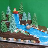 Kayak Cake My dh's 40th birthday cake. My first time modeling anything with fondant (kayak). Trees are ice cream cones & royal icing. It was...