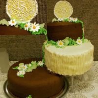 Relief Society Anniversary Cake 12" bottom layer= Applesauce spice cake w/ choc BC10" layer= Lemon cake w/ lemon custard filling and lemon all butter BCoval top...