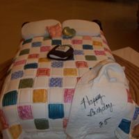 Patchwork Quilt Birthday Cake fondant covered with patchwork quilt cutters. Hand painted squares.