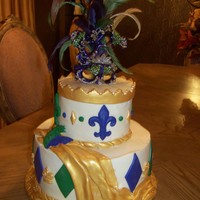 Mardi Gras buttercream with fondant accents, hand painted gold accent