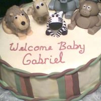 Jungle Babies White cake with fondant icing. All animals were handmade using fondant (some were 50/50 gumpaste). Made to match the shower invitations.