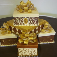 Boxes And Bows This was for a 60th birthday. The cakes in the bottom corners are dummies. the ones on top were cake. Butter yellow flavor and butter cream...