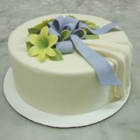 Yellow Lillies The is a styro foam cake covered with choco-pan, gum paste bow and gum paste lillies. The lillies were made with a cutter and mold from...