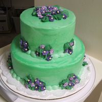 Green Violet I made the violets in 3 shades with royal icing on parchment paper. Then placed on the cake once dry.