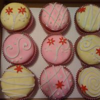 Cupcakes Cream cheese based white chocolate cupcakes with white chocolate betttercream and fondant.