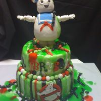 Ghostbusters!! My mess of a fun cake! The marshmellow guy is made of RCT with fondant. All of the other decor is fondant. My favorite part is the glow in...