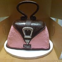 Purse Cake WASC carved, covered in fondant. Buckle is done in gumpaste painted silver with the silver dragees. TFL!!