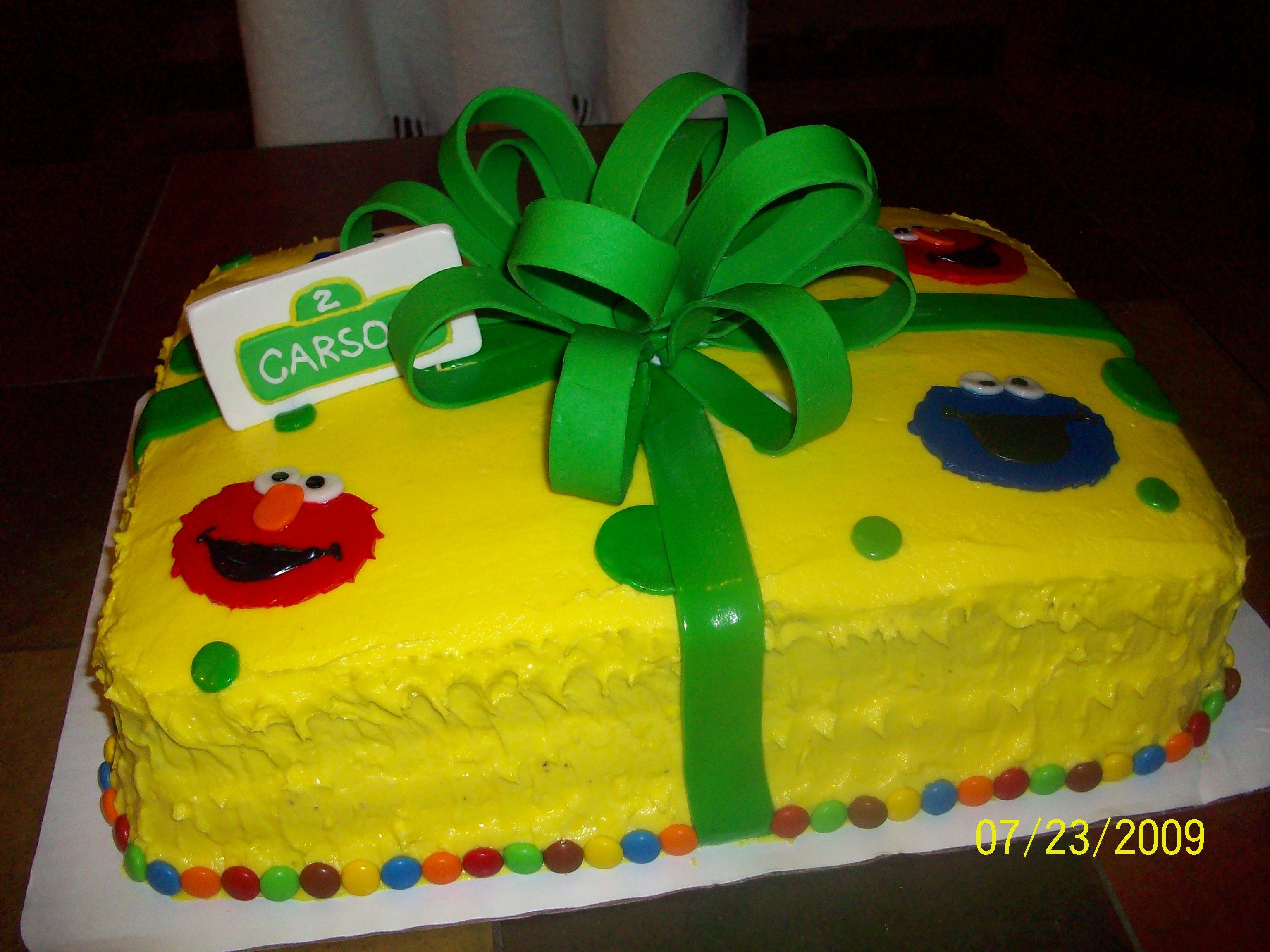Sesame Street Birthday Cake Sesame Street birthday cake with buttercream frosting, fondant decorations and gumpaste bow.