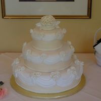 My First Wedding Cake My father-in-law asked me to make his wedding cake while I was still just taking classes. This was my first tiered / fondant cake. Fondant...