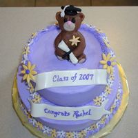 Rachel's Graduation Cake Elementary school graduation. Both tiers are white cake. Top has chocolate pudding filling and bottom has lemon filling. Bear is modeling...