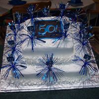 50Th Birthday Cake I made this cake for my husband's 50th birthday.It's all buttercream icing with party picks stuck in the sides of it.