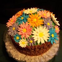 Basket Of Daisies three layer triple fudge chocolate with strawberry cream filling. Gumpaste daisies, buttercream basket weave.