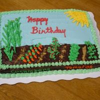 My First Decorated Cake Chocolate fudge cake, BC icing and decorations. For my dad who loves his garden. Corn, beans, carrots, tomatoes, cabbage - all his...