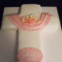 God Bless Cora WASC, torted and filled with BC, covered in fondant. Fondant swag. Gumpaste flowers and plaque. Cross cut using template on CC. Thanks.
