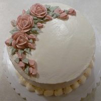 Simple Cake With Roses This was a dark chocolate cake, torted and filled with raspberry buttercream and then iced and decorated with meringue buttercream.